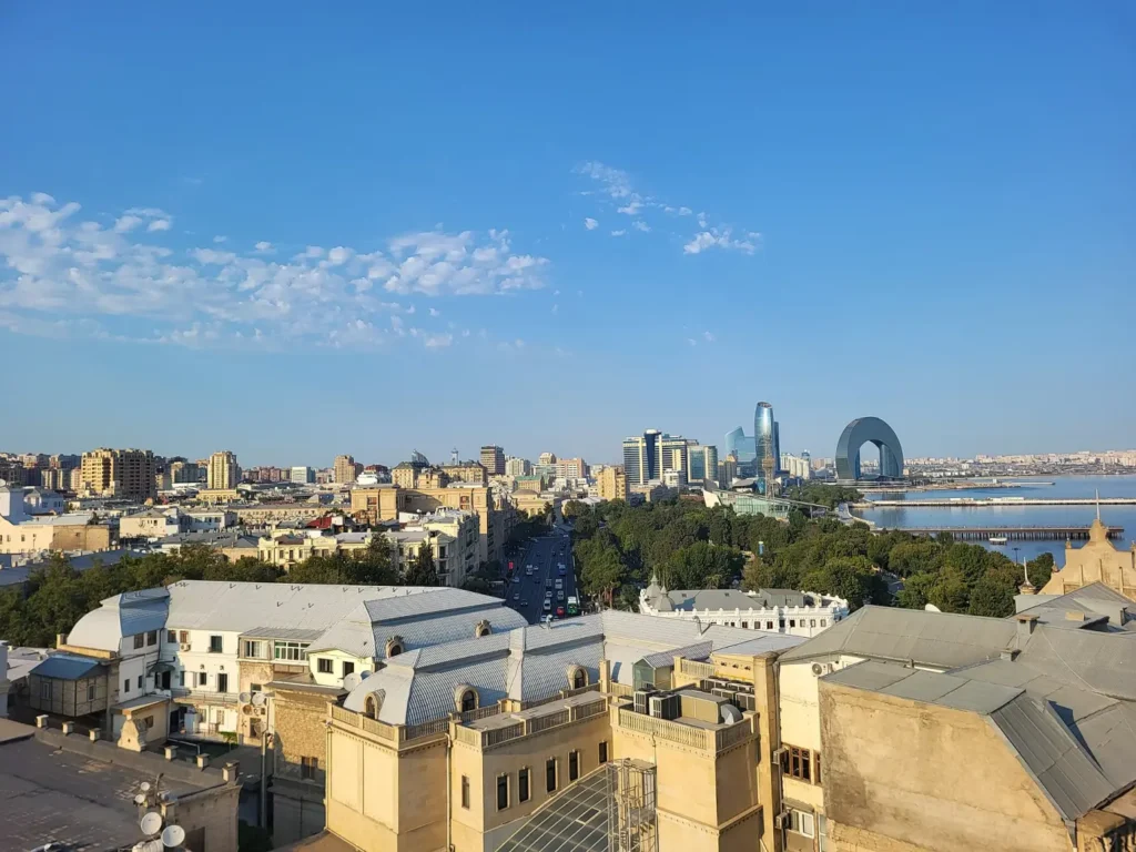 Old City rooftops in Baku with the Flame Towers and the bay behind