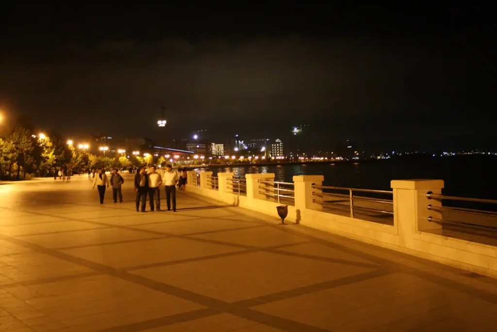 People walking the Baku seaside promenade at night