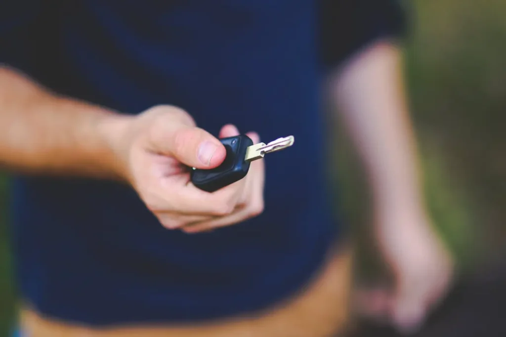 A hand passing over a car key