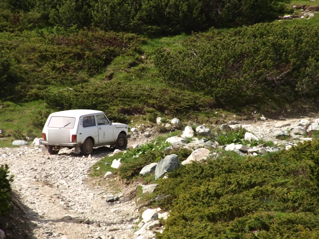 A Lada Niva 4x4 on a rocky mountain track