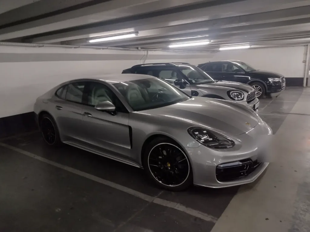 A silver Porsche Panamera in an underground car park