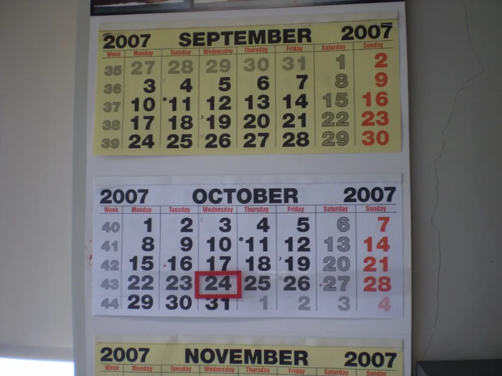 A wall calendar with two months and one date circled