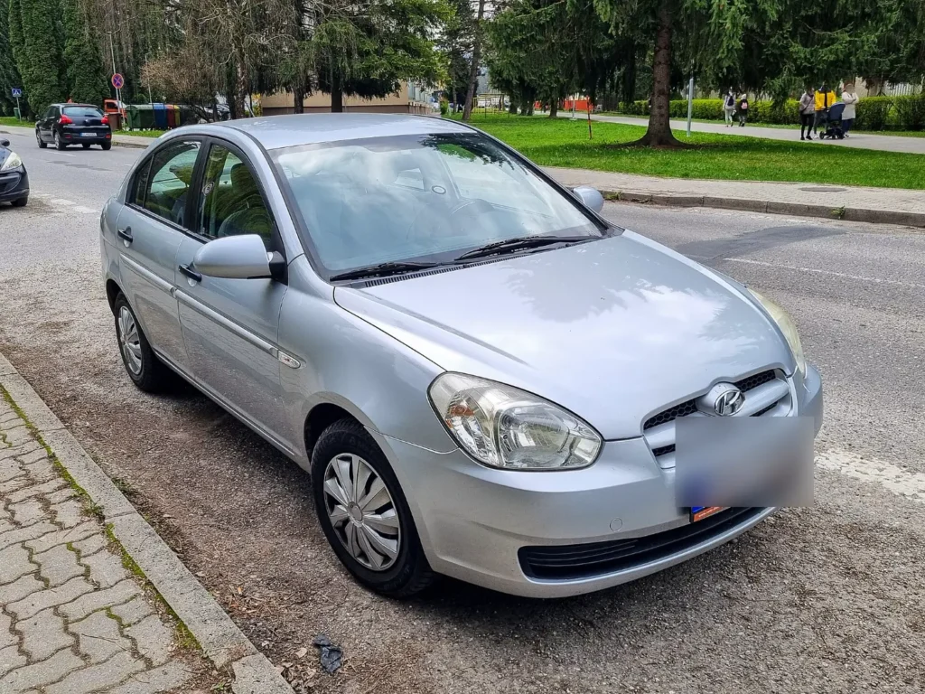 A silver Hyundai Accent sedan parked on a street