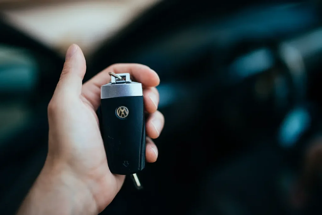 A hand holding a car key