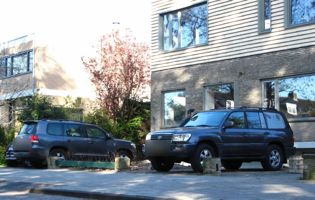 A Toyota Land Cruiser 200 and a Land Cruiser 100 parked side by side